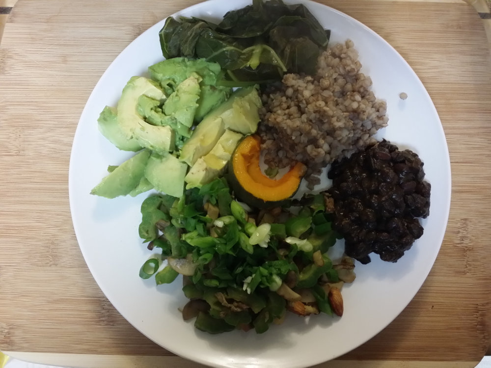 A sample meal with beans, avocado, bitter melon, squash, greens, and buckwheat